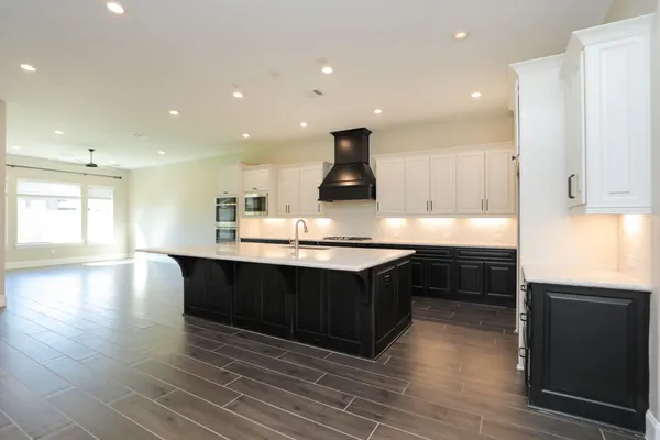 a kitchen with stainless steel appliances granite countertop a sink counter space and cabinets