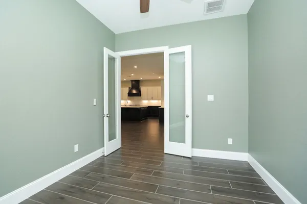 a view of a room with wooden floor and a bathroom sink