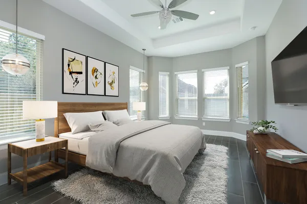 a bedroom with a bed and a flat screen tv