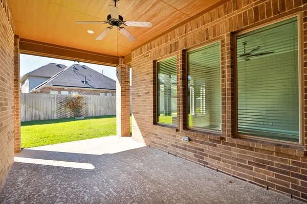 a view of a brick house with a large window