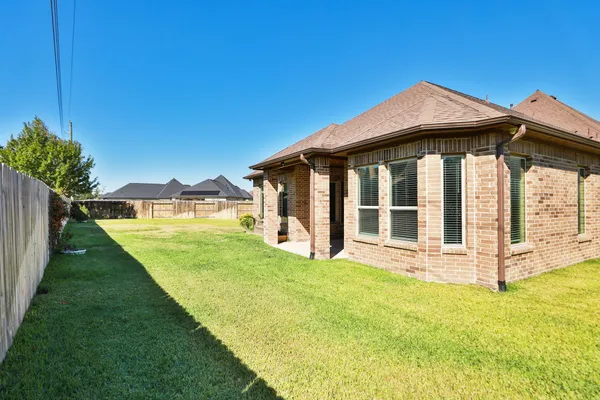 a view of a house with a yard and porch