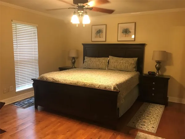 a large bed sitting in a bedroom next to a window