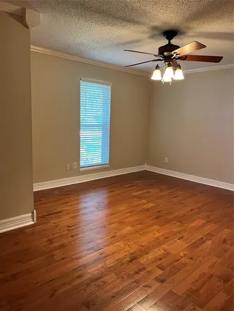 a view of a room with wooden floor and fan