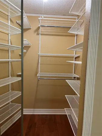 a view of walk in closet with empty racks