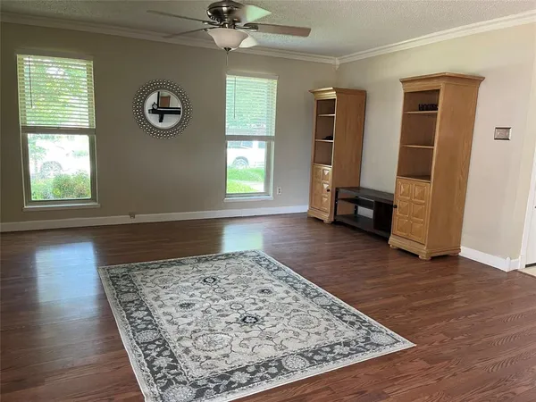 a view of a livingroom with wooden floor and a window