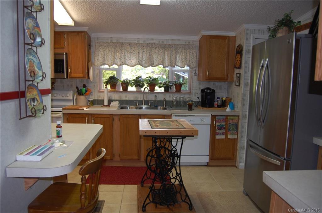 157 Green Road Star, NC 27356 - Photo 5 of 7 a kitchen with stainless steel appliances a sink cabinets and a refrigerator
