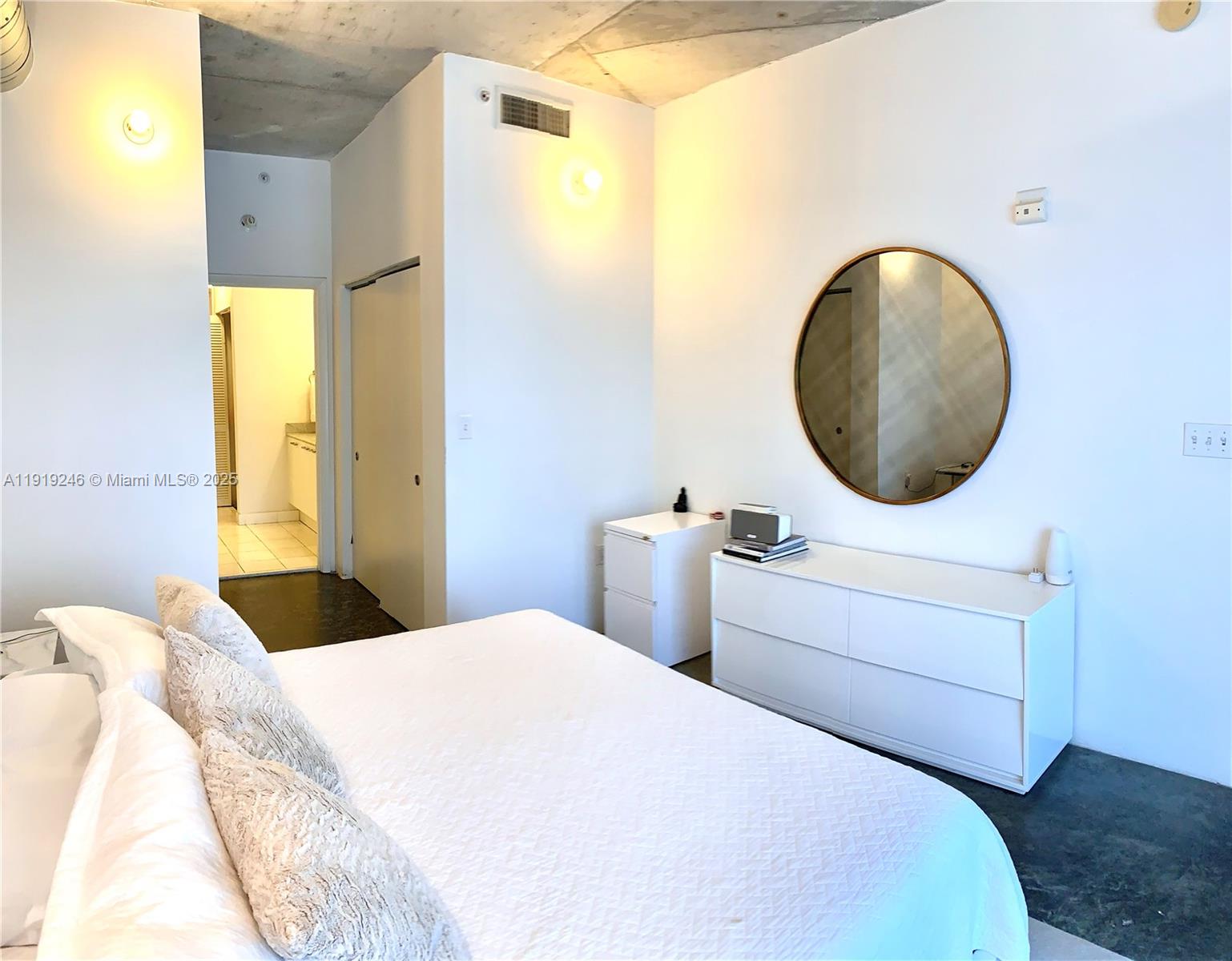 2001 Meridian Avenue, Unit 330 Miami Beach, FL 33139 - Photo 8 of 19 a bedroom with a bed and a painting on the wall