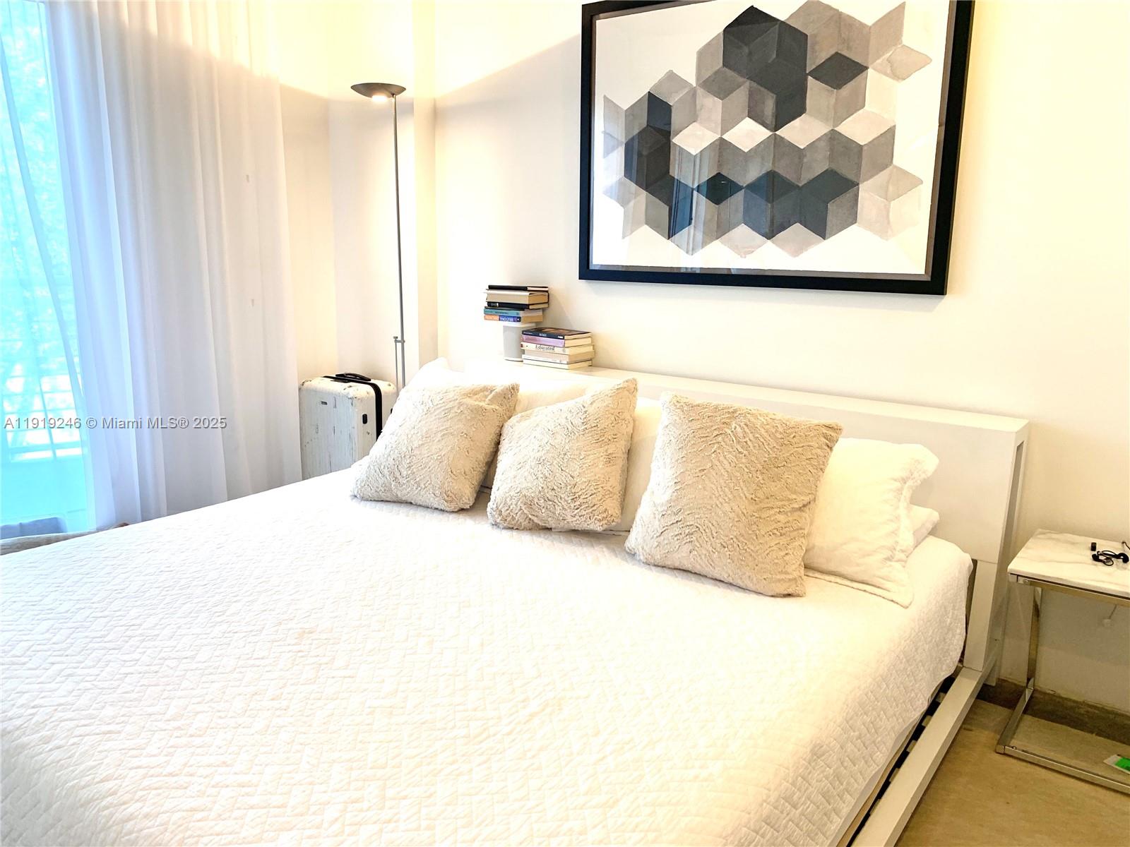 2001 Meridian Avenue, Unit 330 Miami Beach, FL 33139 - Photo 9 of 19 a bedroom with a bed and a painting on the wall