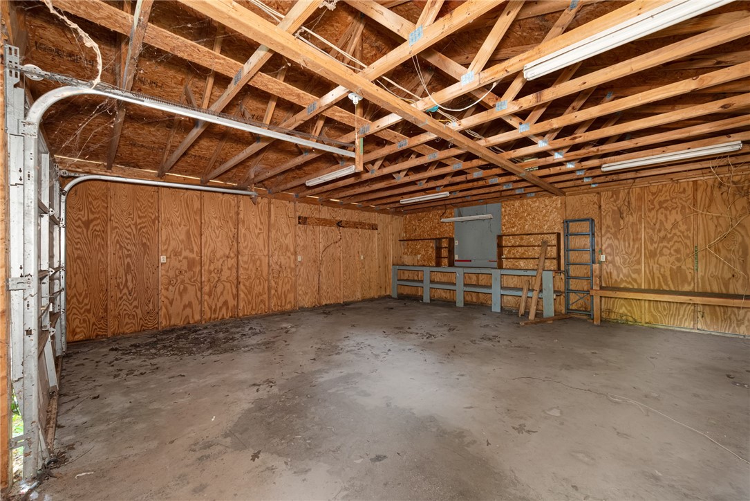 403 Lewis Street Anderson, SC 29624 - Photo 20 of 35 Exposed wood framing and concrete flooring define this versatile storage or workshop space.