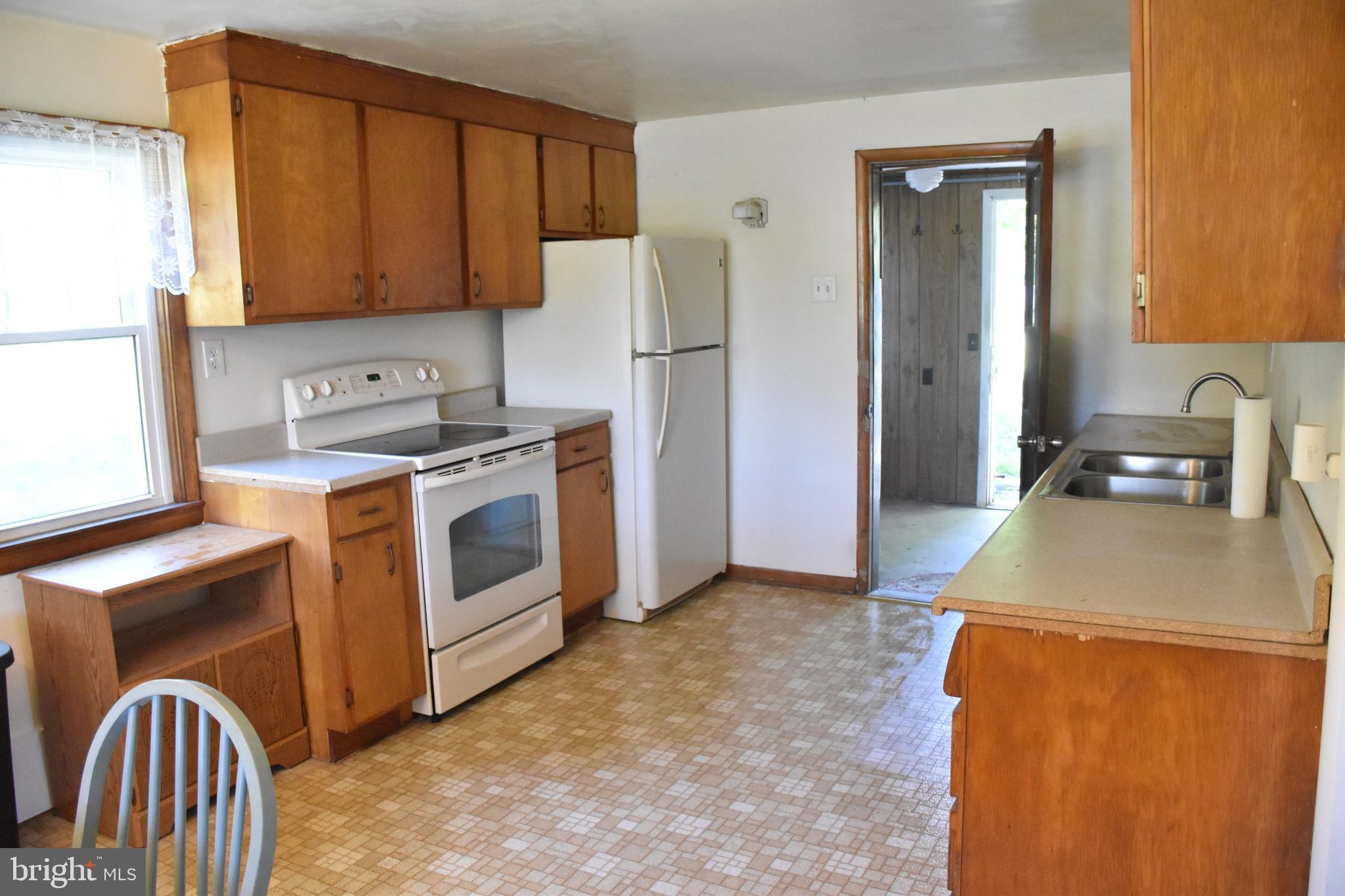 1362 New Road Orrtanna, PA 17353 - Photo 17 of 28 a kitchen with stainless steel appliances granite countertop a stove a sink dishwasher and a refrigerator