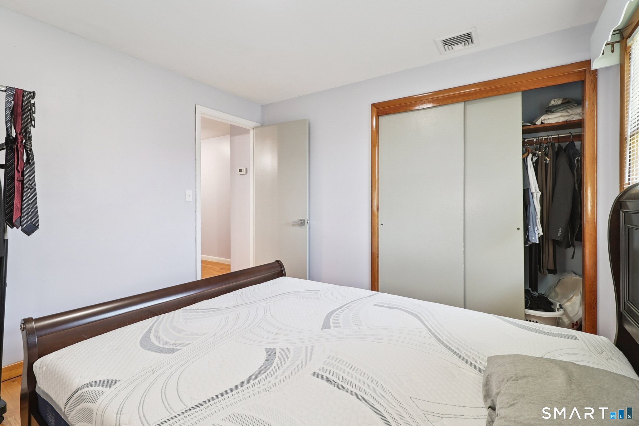 72 Hilltop Road Naugatuck, CT 06770 - Photo 18 of 25 a bedroom with a bed and a mirror