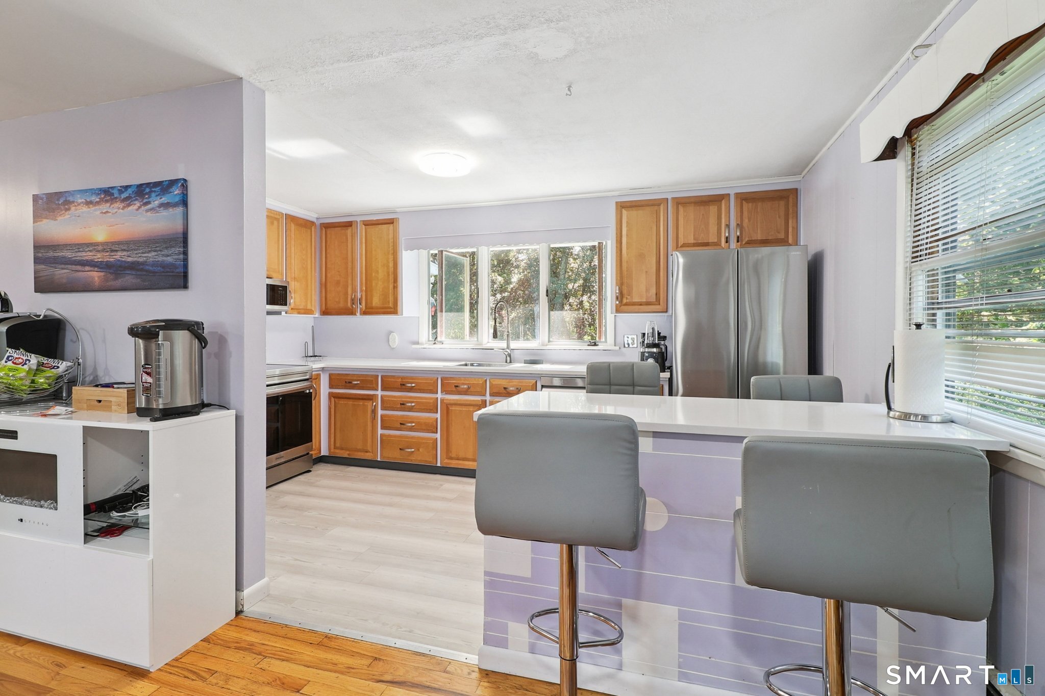 72 Hilltop Road Naugatuck, CT 06770 - Photo 8 of 25 a living room with stainless steel appliances granite countertop a couch and a refrigerator