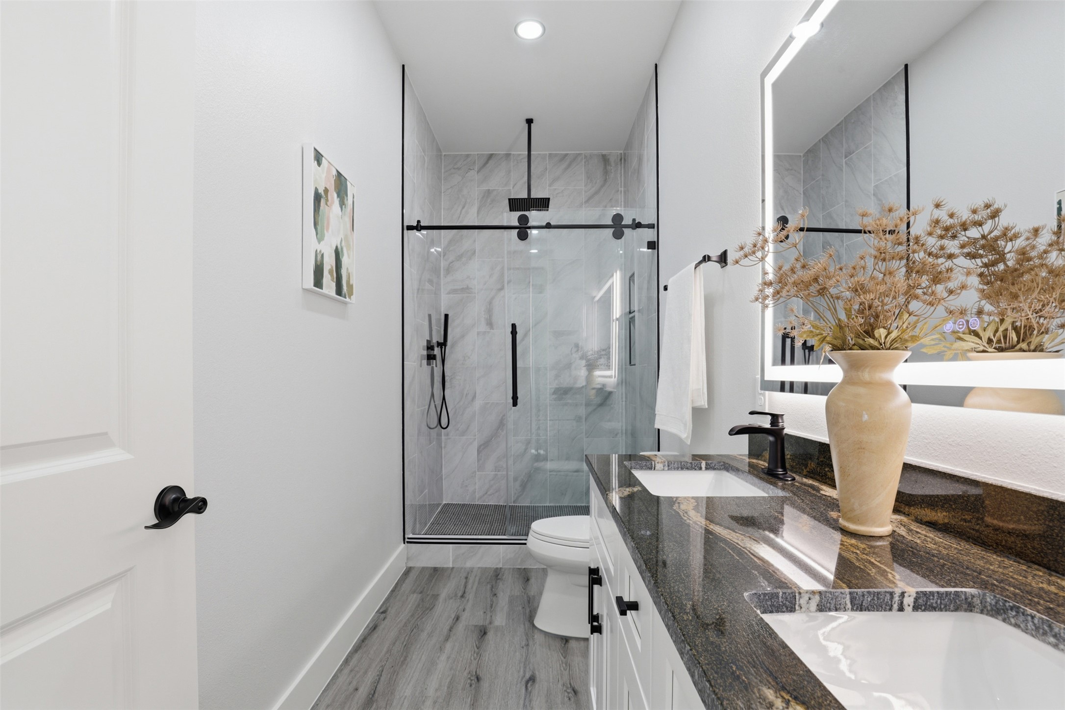 113 Los Robles Road Elgin, TX 78621 - Photo 15 of 20 Bathroom featuring a dual vanity with undermount sinks and a dark, veined countertop