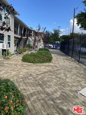 a street sign on a sidewalk next to a building