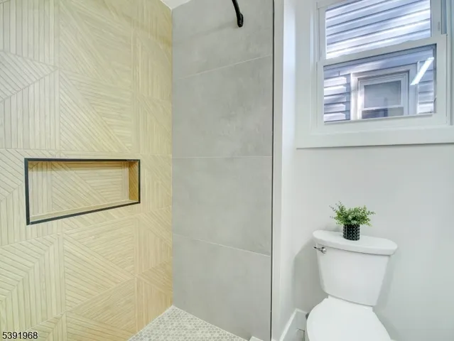 a living room with furniture and painting on the wall