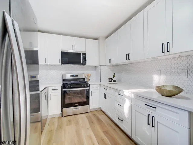 a view of a hallway with closet and wooden floor