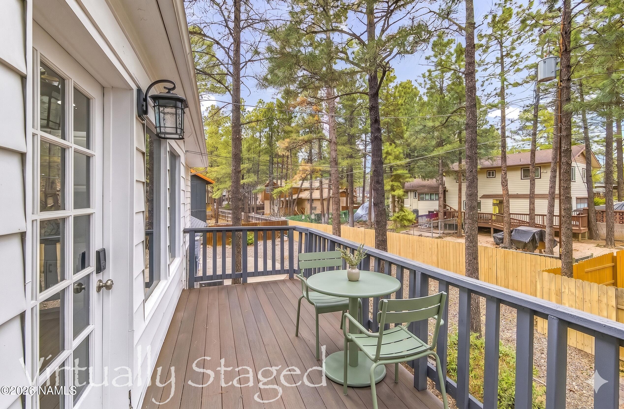 530 East Charles Road Flagstaff, AZ 86001 - Photo 43 of 54 a view of a balcony with wooden floor and outdoor seating