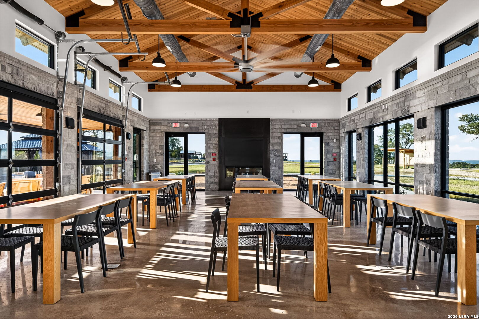 5386 Ranch Road 1376, Unit 64 Fredericksburg, TX 78624 - Photo 24 of 45 a view of a patio with dining table and chairs with wooden floor