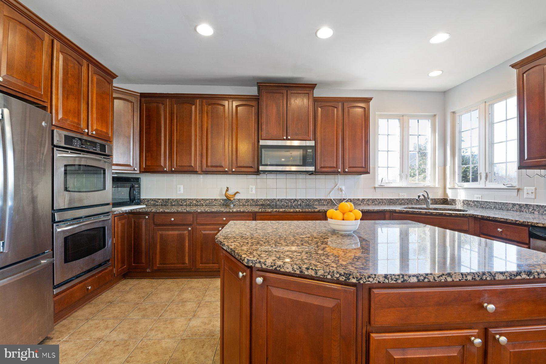 14206 Derby Ridge Road Bowie, MD 20721 - Photo 24 of 77 a kitchen with granite countertop a stove sink and cabinets