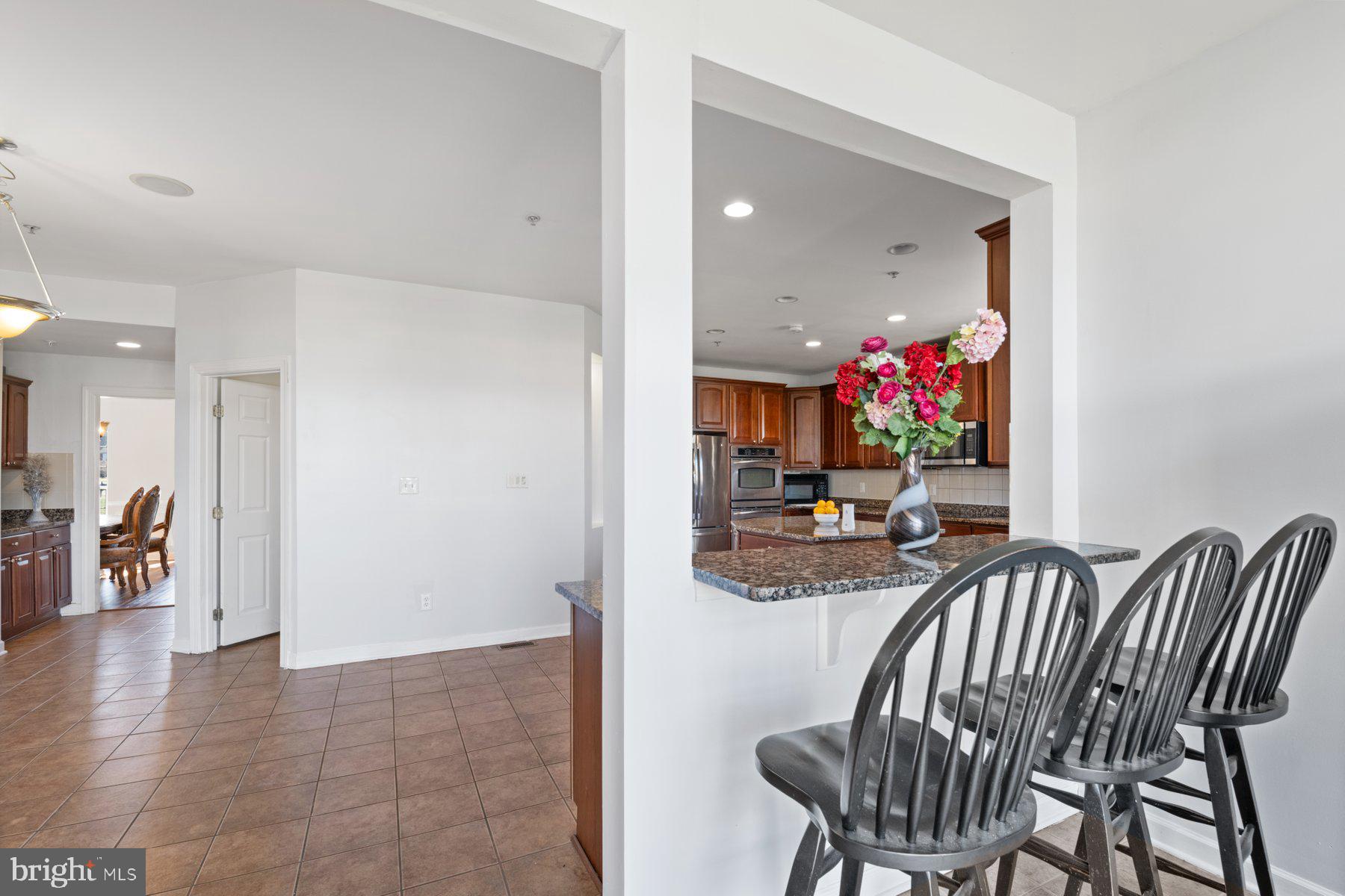 14206 Derby Ridge Road Bowie, MD 20721 - Photo 29 of 77 a view of a dining room with furniture and a potted plant