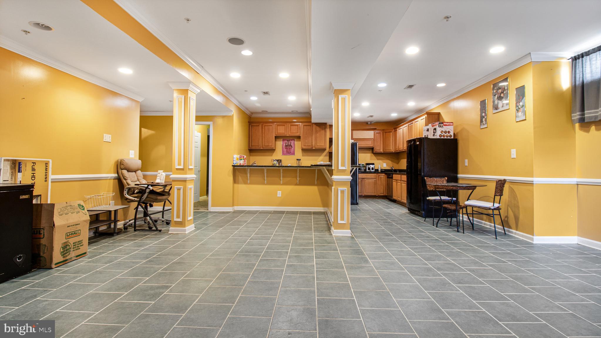 14206 Derby Ridge Road Bowie, MD 20721 - Photo 49 of 77 a view of a kitchen with kitchen island a large window cabinets and stainless steel appliances