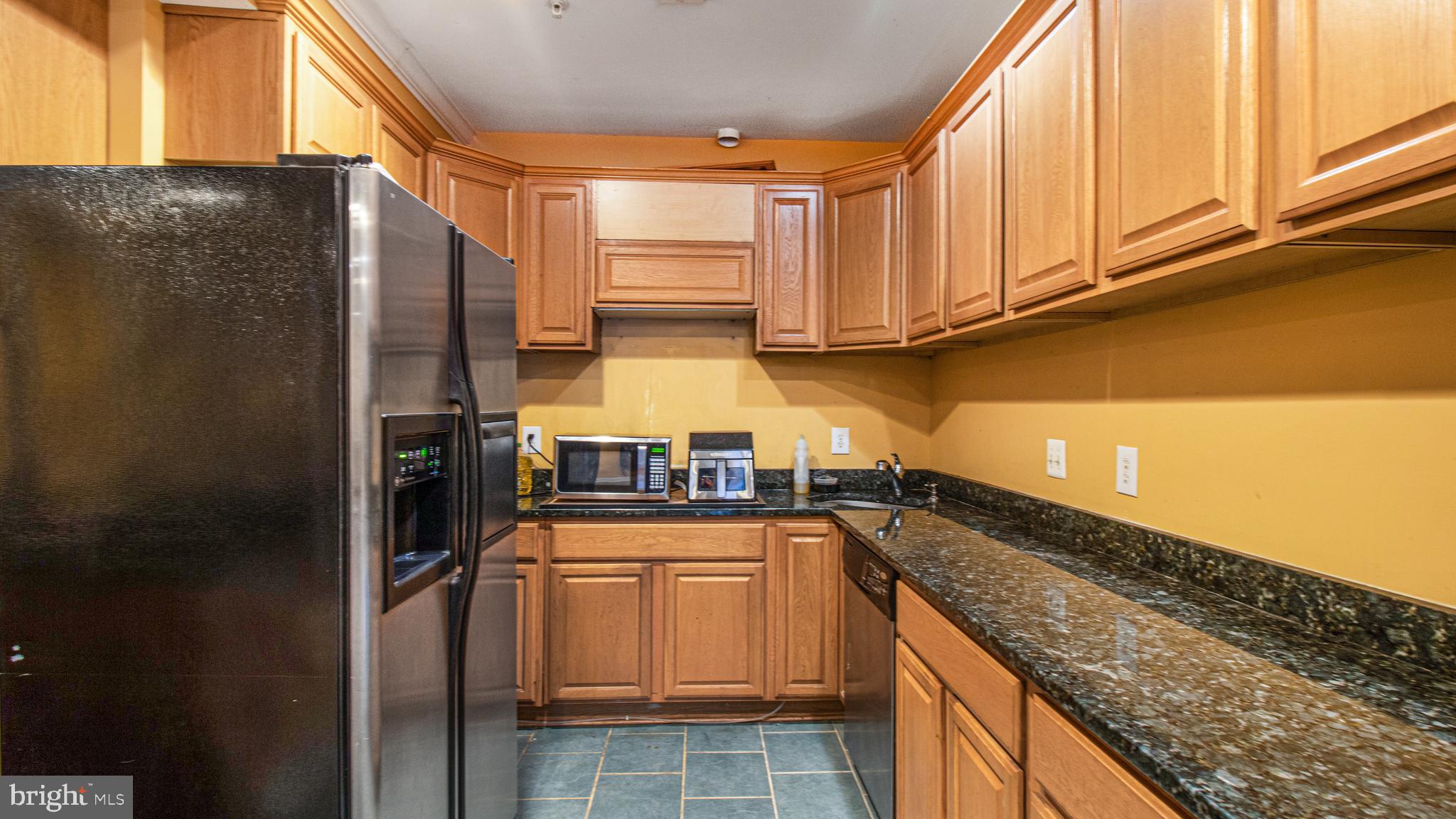 14206 Derby Ridge Road Bowie, MD 20721 - Photo 58 of 77 a kitchen with granite countertop a refrigerator and a sink