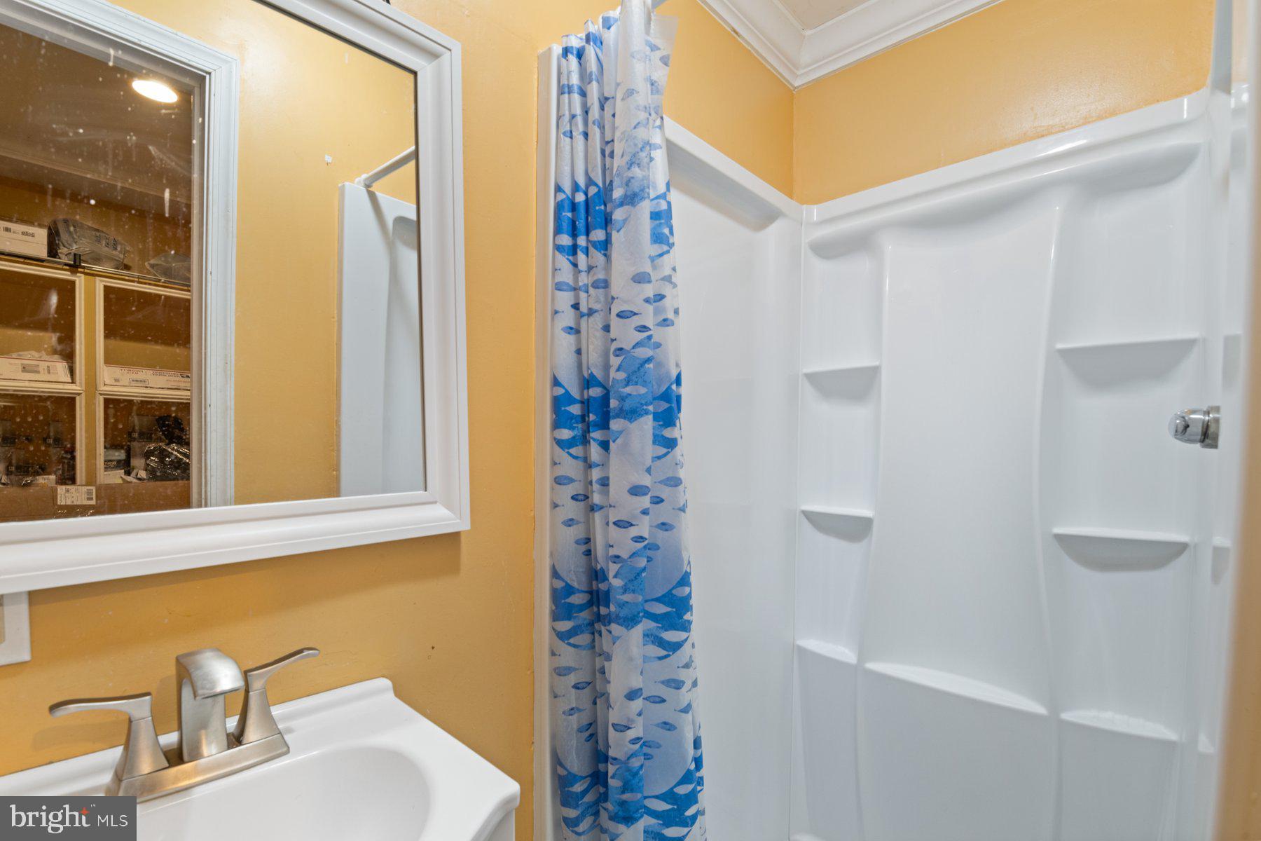 14206 Derby Ridge Road Bowie, MD 20721 - Photo 65 of 77 a bathroom with a shower curtain and a sink