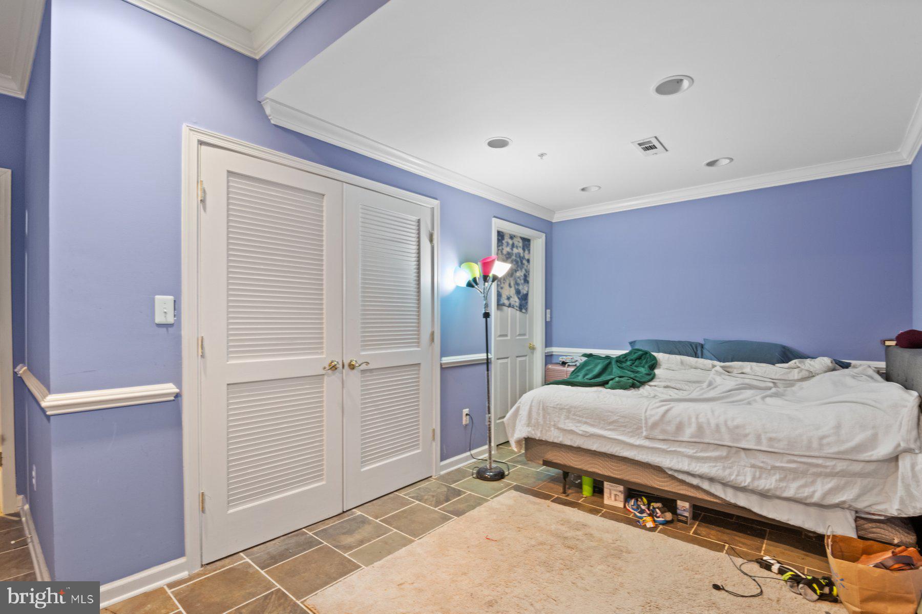 14206 Derby Ridge Road Bowie, MD 20721 - Photo 66 of 77 a bedroom with a bed and a chandelier