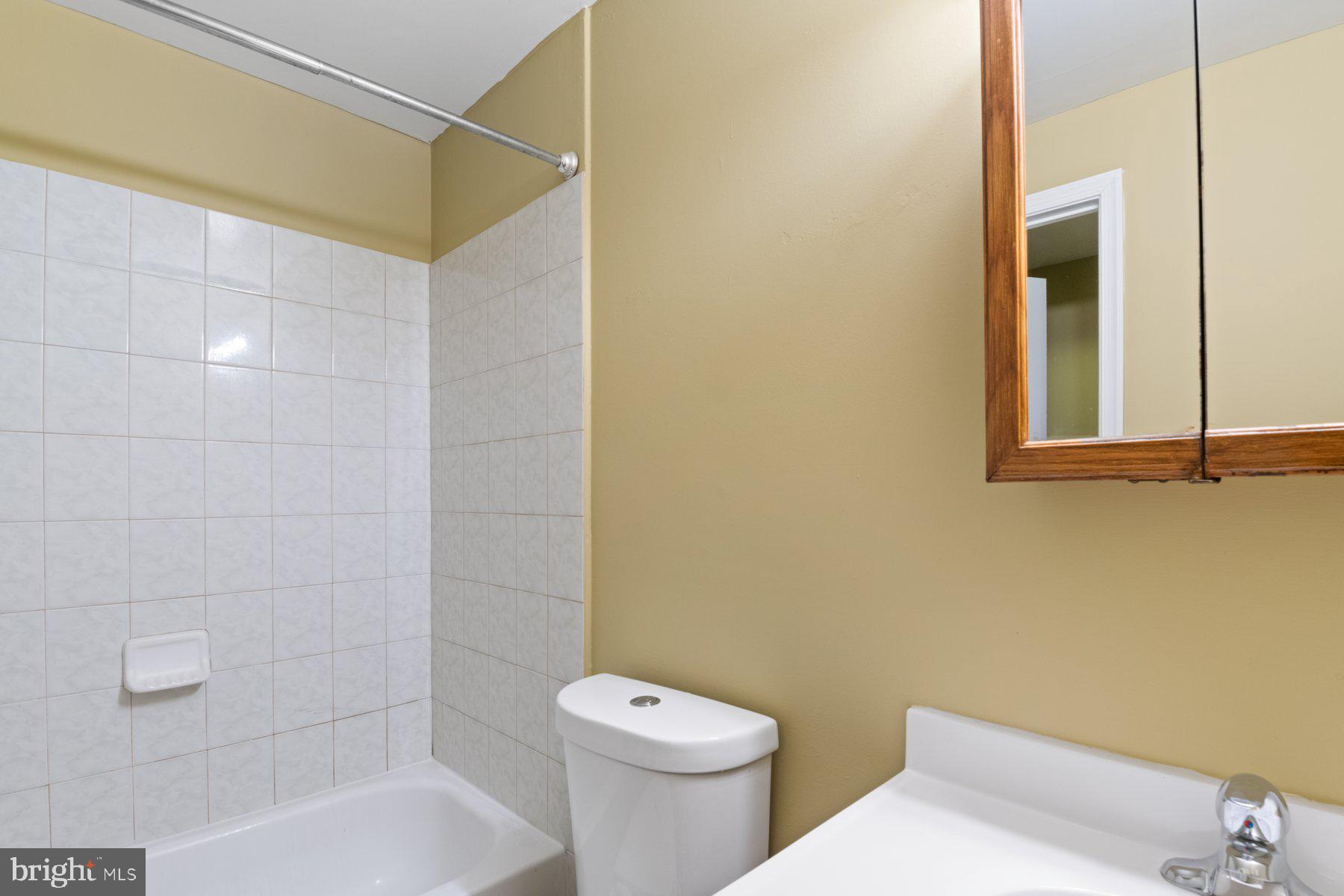 14206 Derby Ridge Road Bowie, MD 20721 - Photo 70 of 77 a white toilet sitting next to a bath tub and a shower