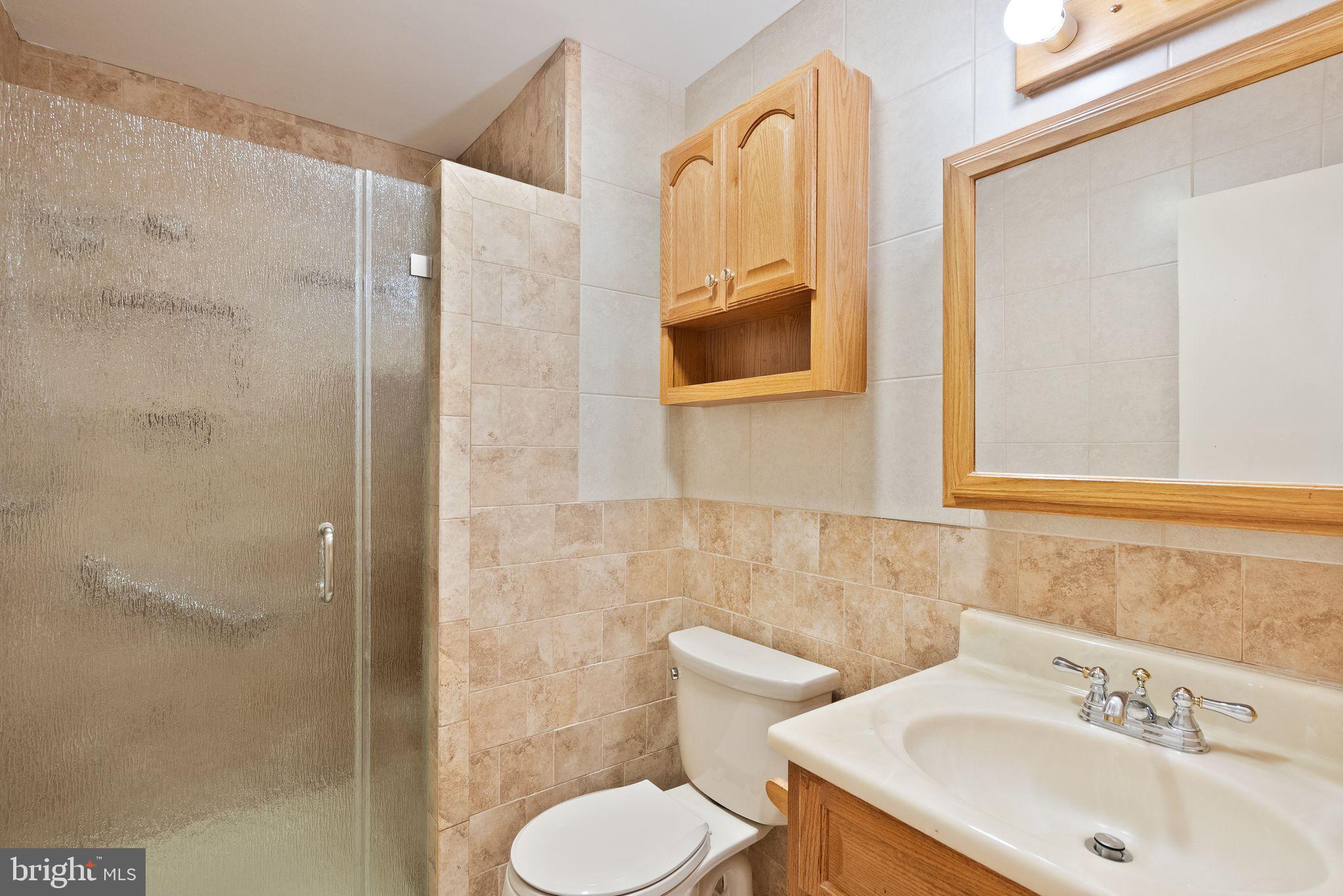8522 Tysons Court Vienna, VA 22182 - Photo 12 of 27 a bathroom with a sink toilet and shower
