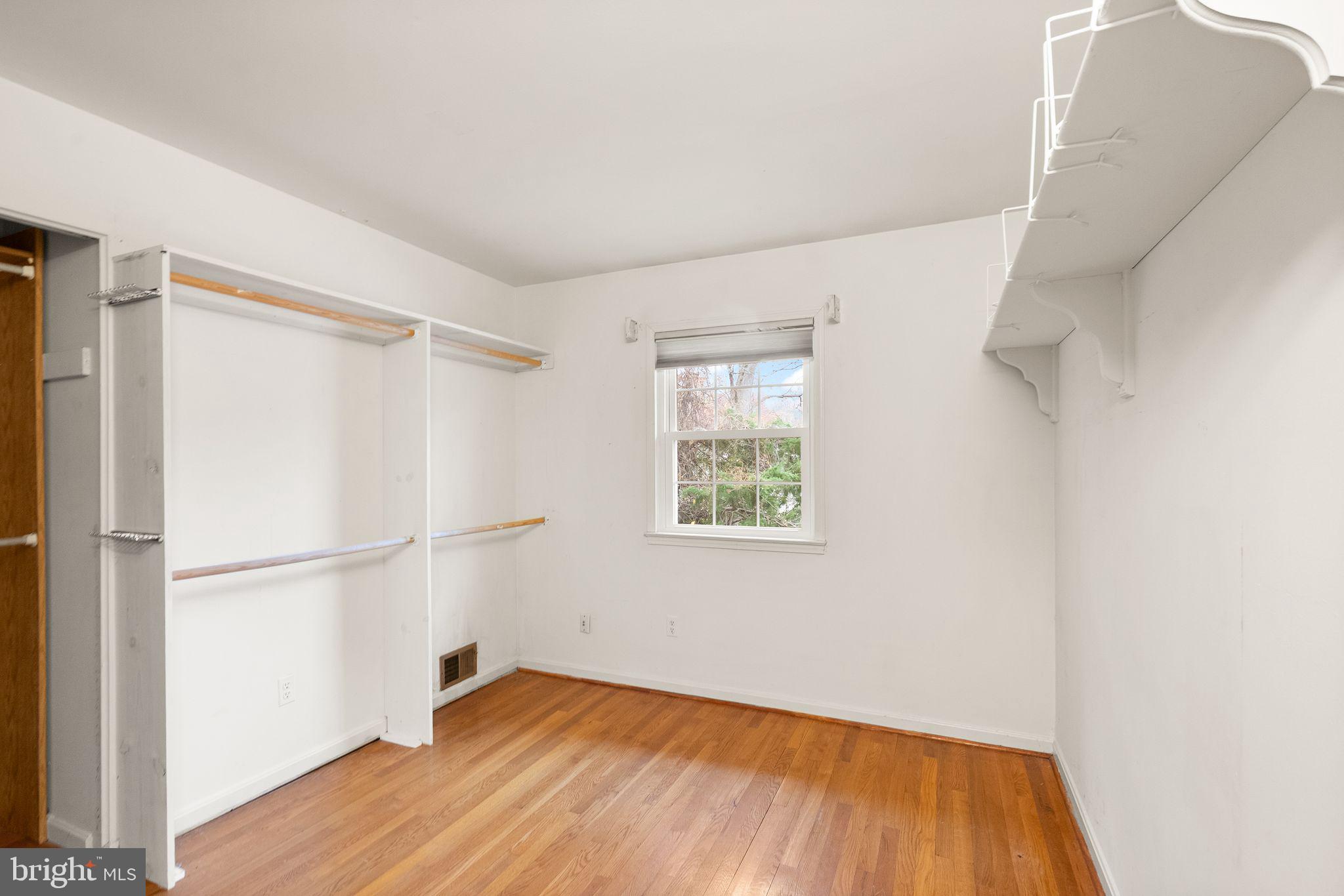8522 Tysons Court Vienna, VA 22182 - Photo 15 of 27 a view of an empty room with wooden floor and a window