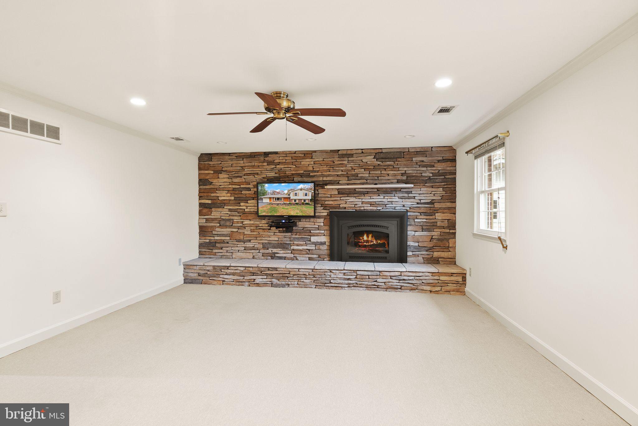 8522 Tysons Court Vienna, VA 22182 - Photo 9 of 27 a view of a livingroom with a fireplace and a ceiling fan