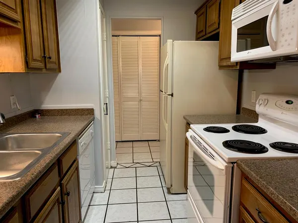 a kitchen with a sink stove and refrigerator