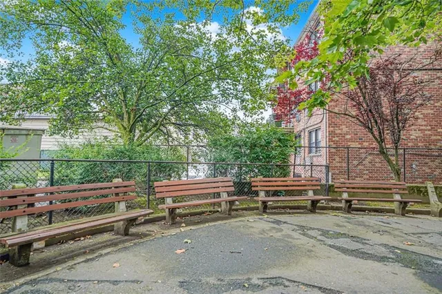 a backyard of a house with barbeque oven and outdoor seating
