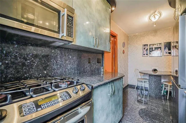 a stove top oven sitting inside of a kitchen