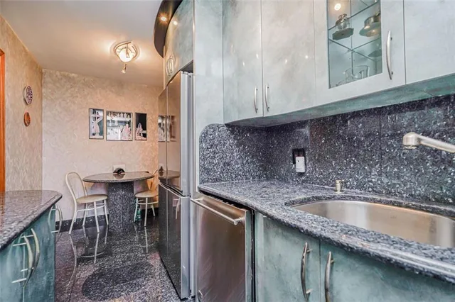 a kitchen with a sink a table and chairs