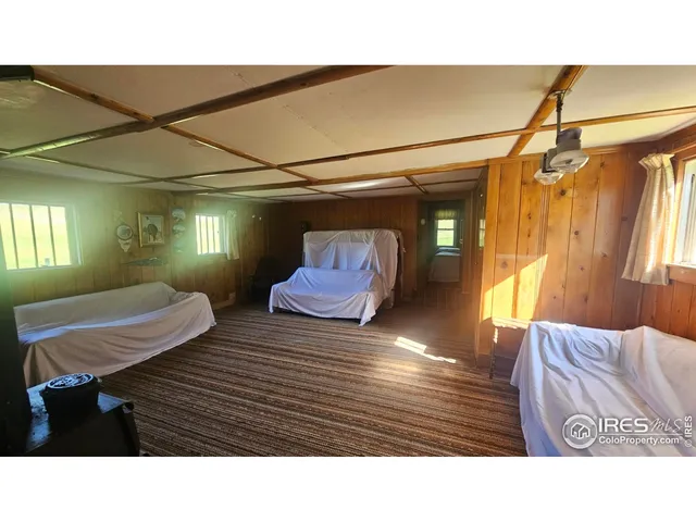 a bedroom with a bed lamp and a window