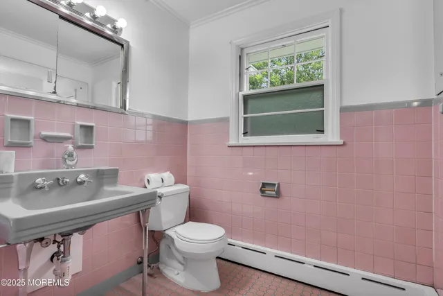 a bathroom with a sink a toilet and mirror