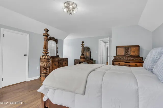 a bedroom with a bed and a tv on table