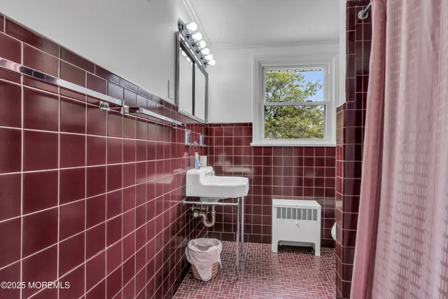 a bathroom with a sink a toilet and a window