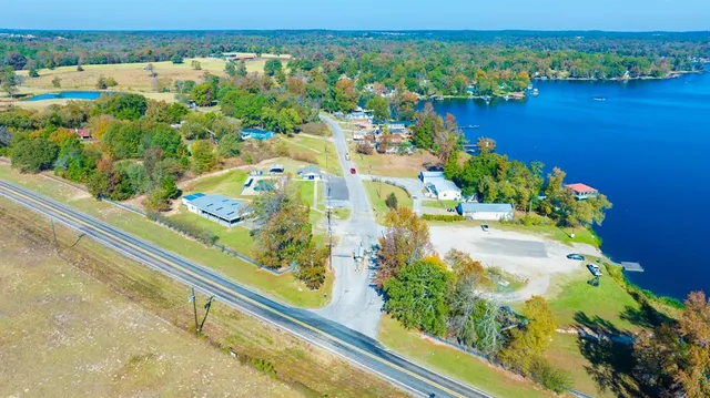 an aerial view of lake and residential houses with outdoor space