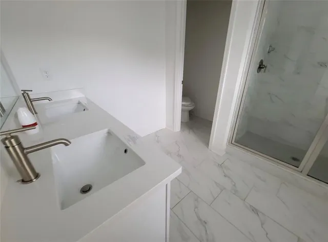 a bathroom with a tub and toilet