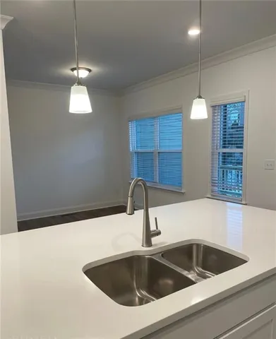 a kitchen with a sink and chandelier