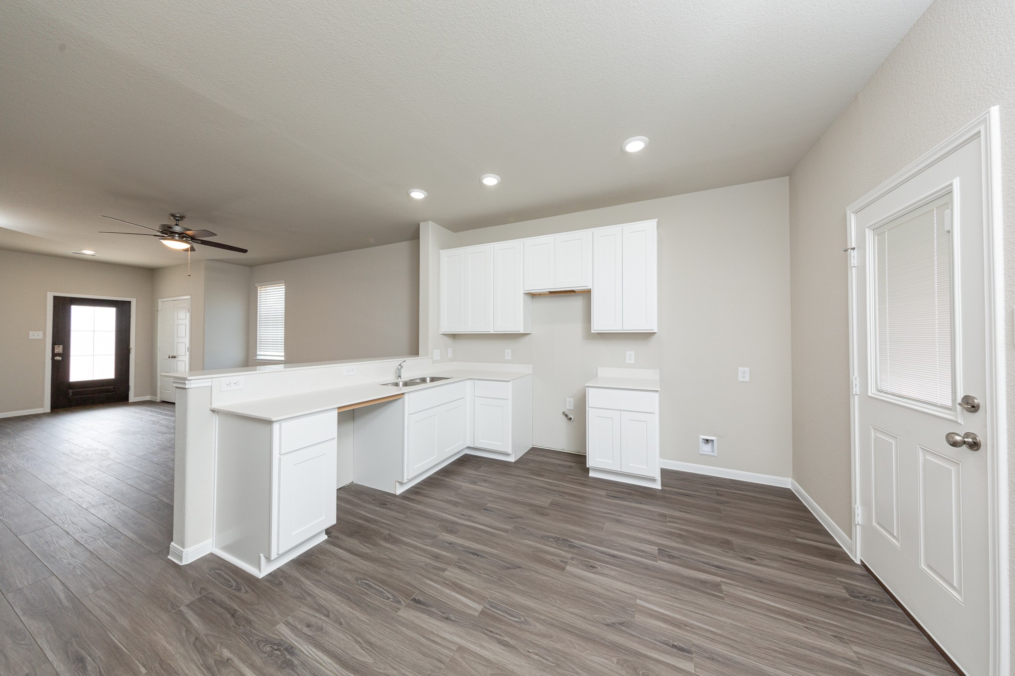9258 Grace Rdg Drive Willis, TX 77318 - Photo 2 of 24 a kitchen with a sink and wooden floor