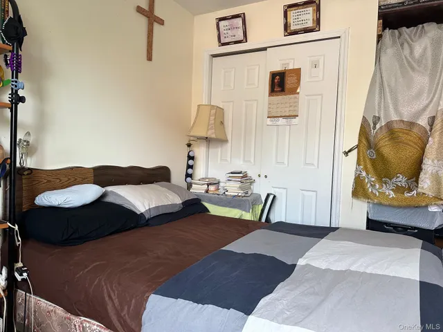 a bedroom with a bed and a chair