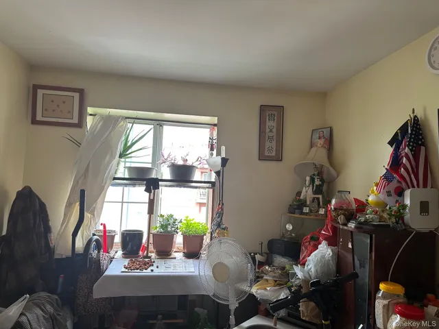 a room with furniture toys and a large window