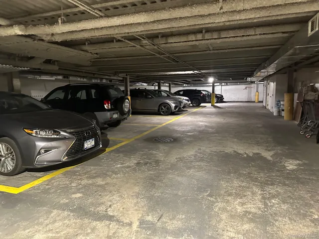 a view of parking garage with cars