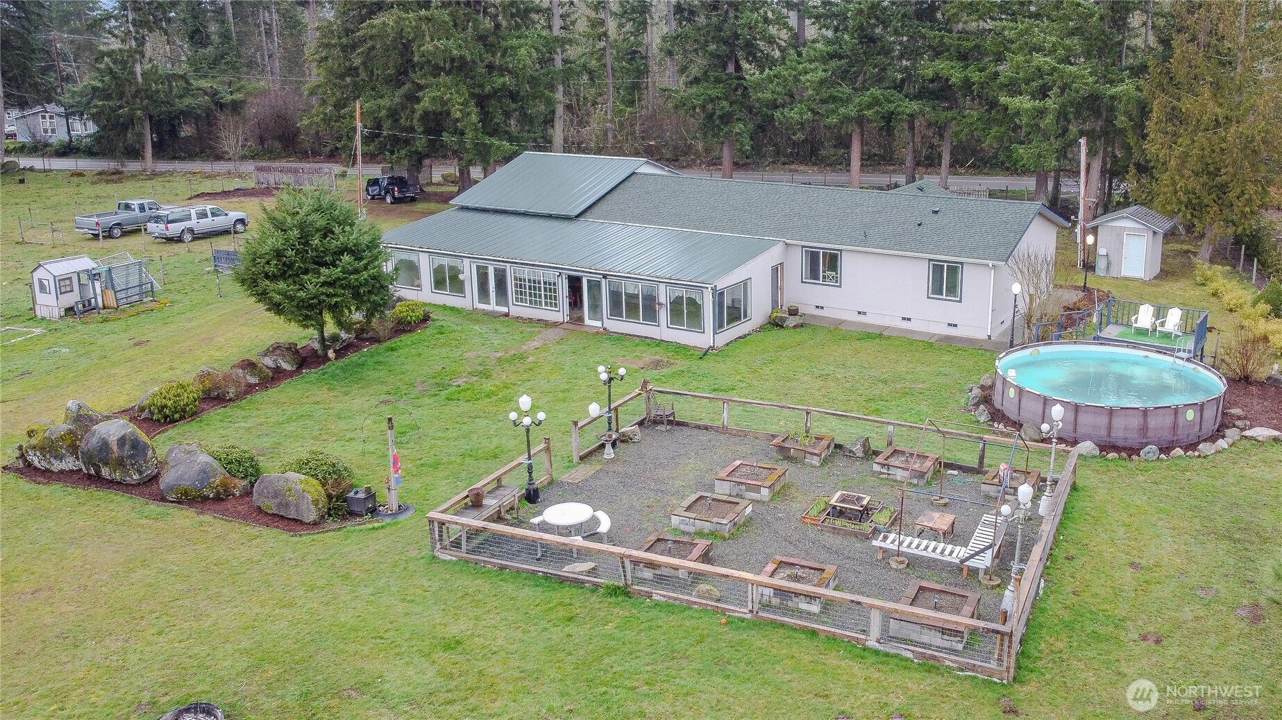 an aerial view of a house with swimming pool garden and outdoor seating
