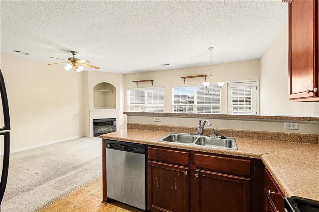 7676 Rutgers Circle Fairburn, GA 30213 - Photo 15 of 33 a kitchen with stainless steel appliances granite countertop a sink a stove and a refrigerator