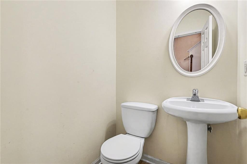7676 Rutgers Circle Fairburn, GA 30213 - Photo 17 of 33 a white toilet sitting next to a bathroom sink
